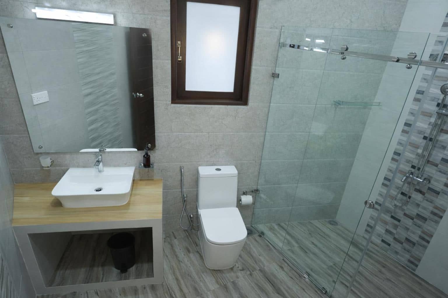 Modern bathroom with vessel basin and glass-walled rain shower