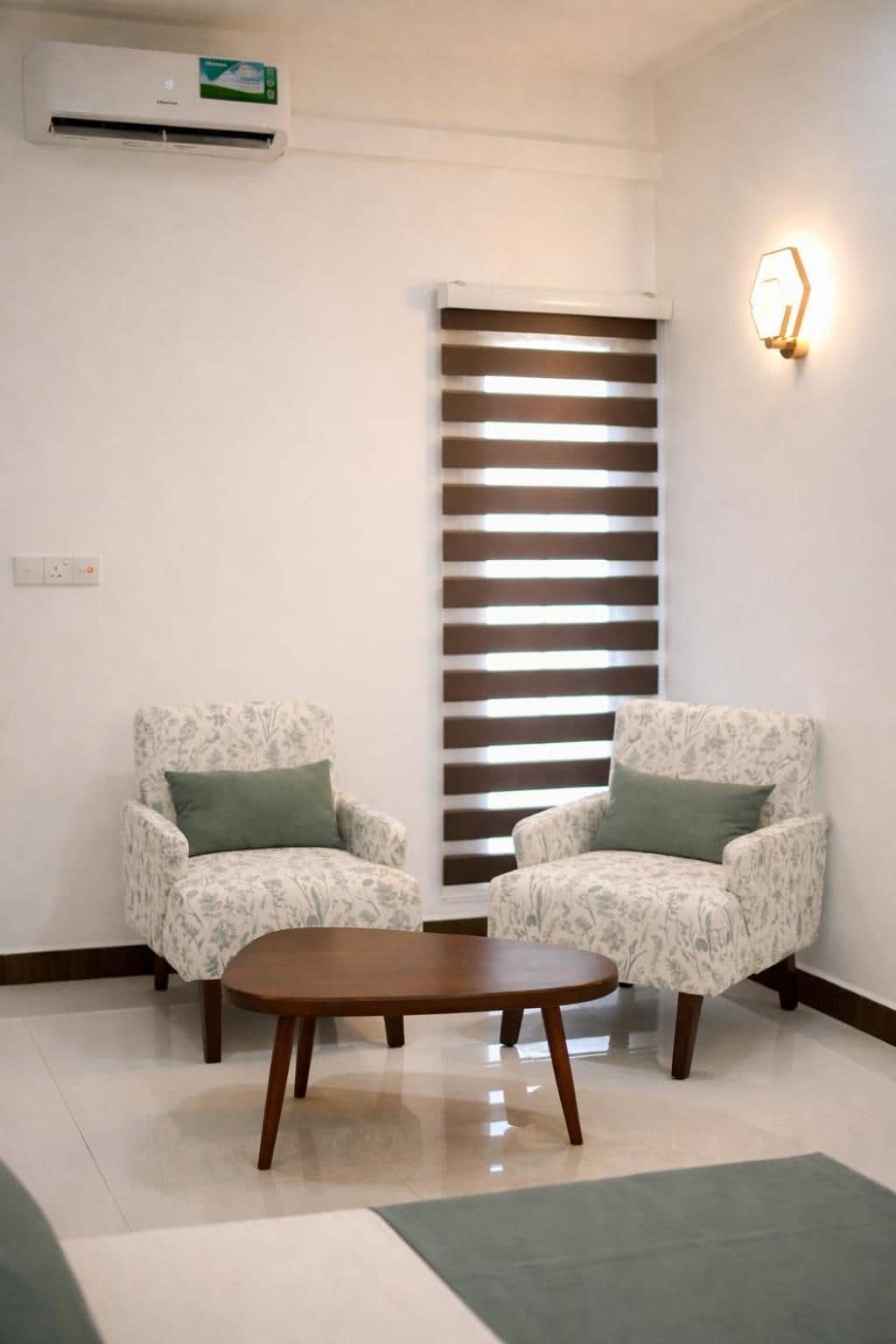 Pair of armchairs and a round coffee table beside the window