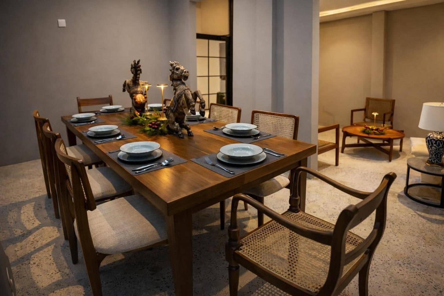 Private dining room with carved timber chairs and a set table