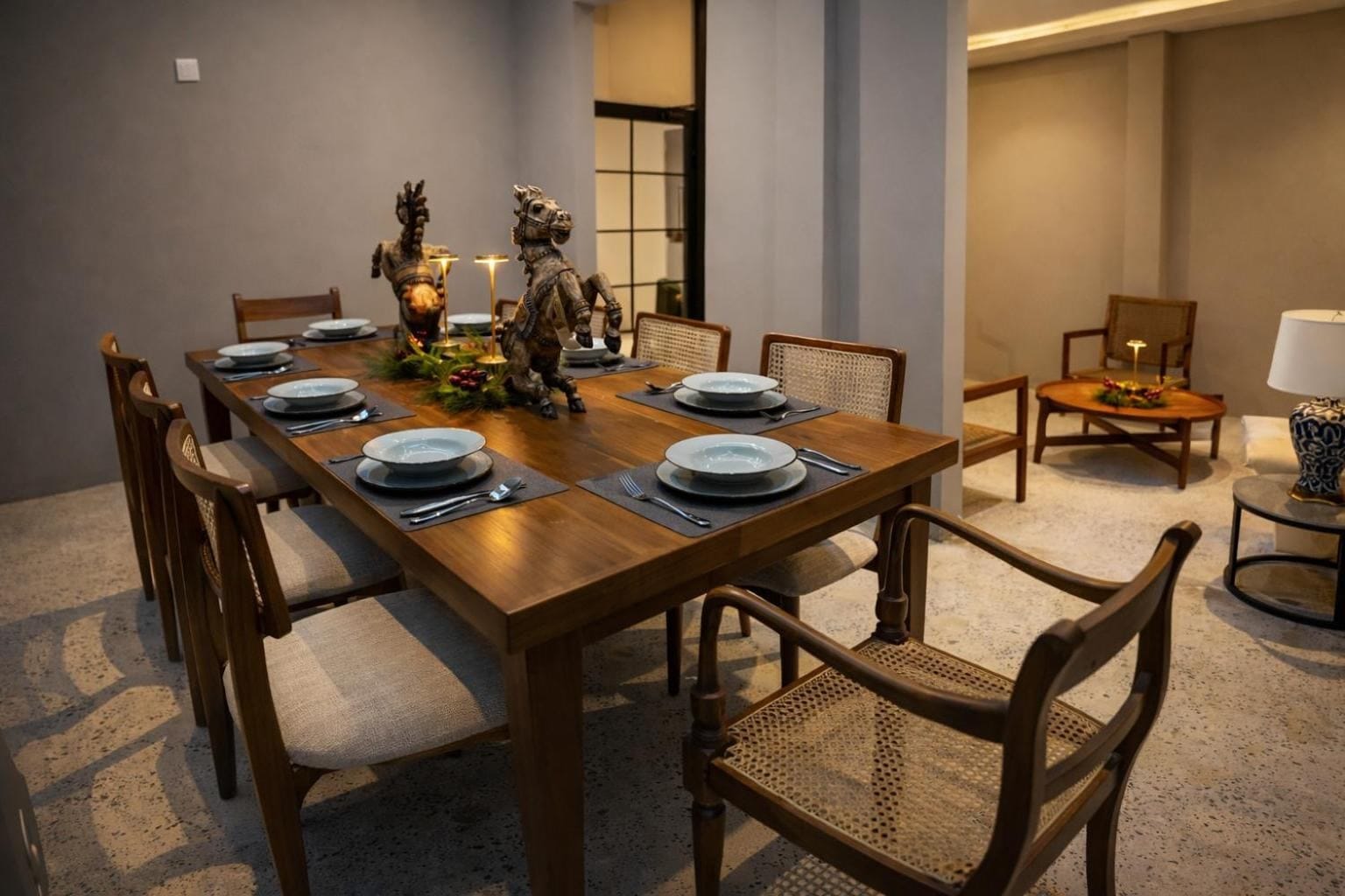 Private dining room with carved timber chairs and a set table