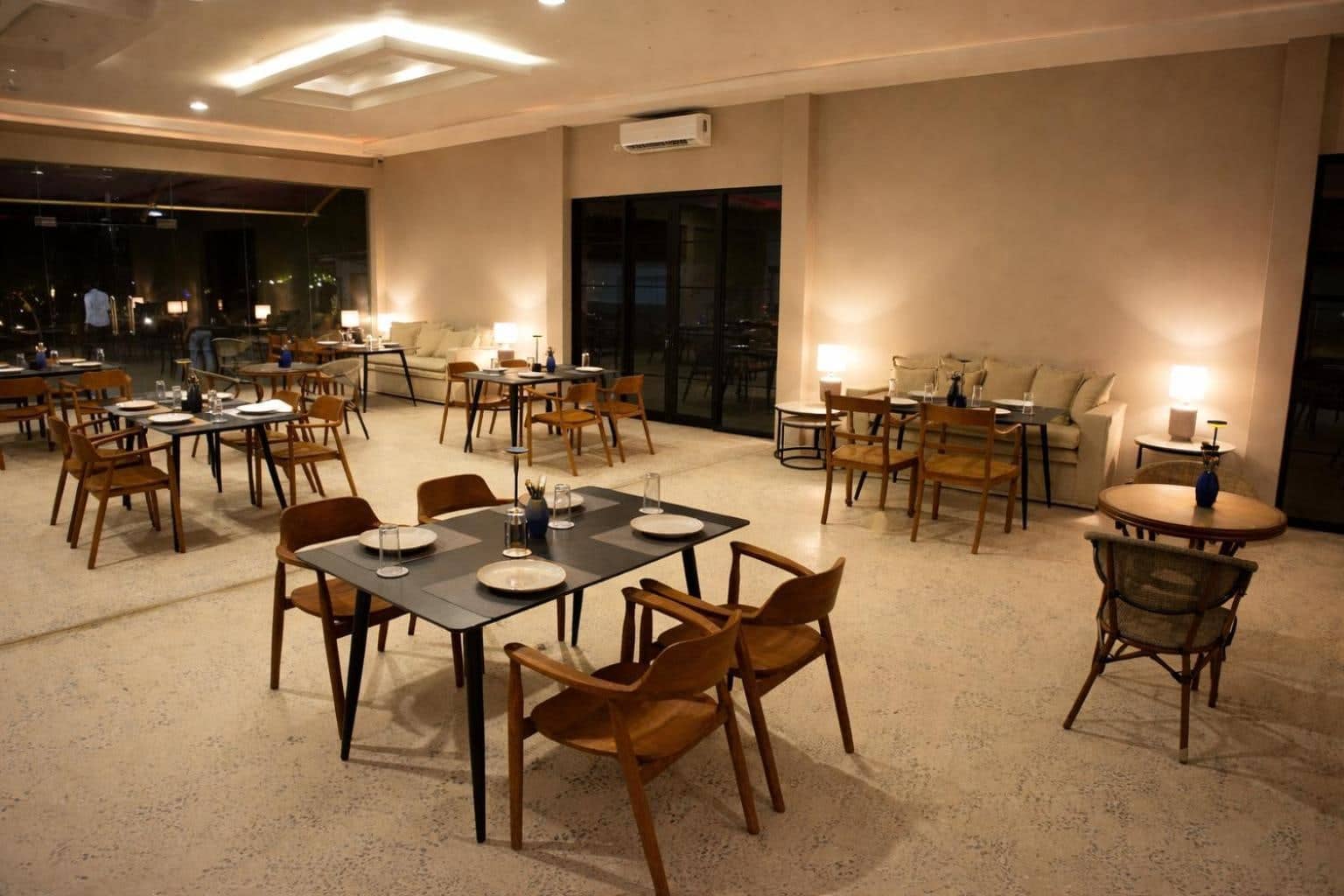 Yaazoraa restaurant in Anuradhapura at night, with warm lamps and timber chairs